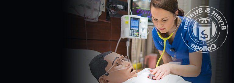 Nursing student working with medical dummy
