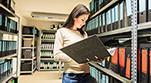 File Clerk reviewing records in the Medical Records stack
